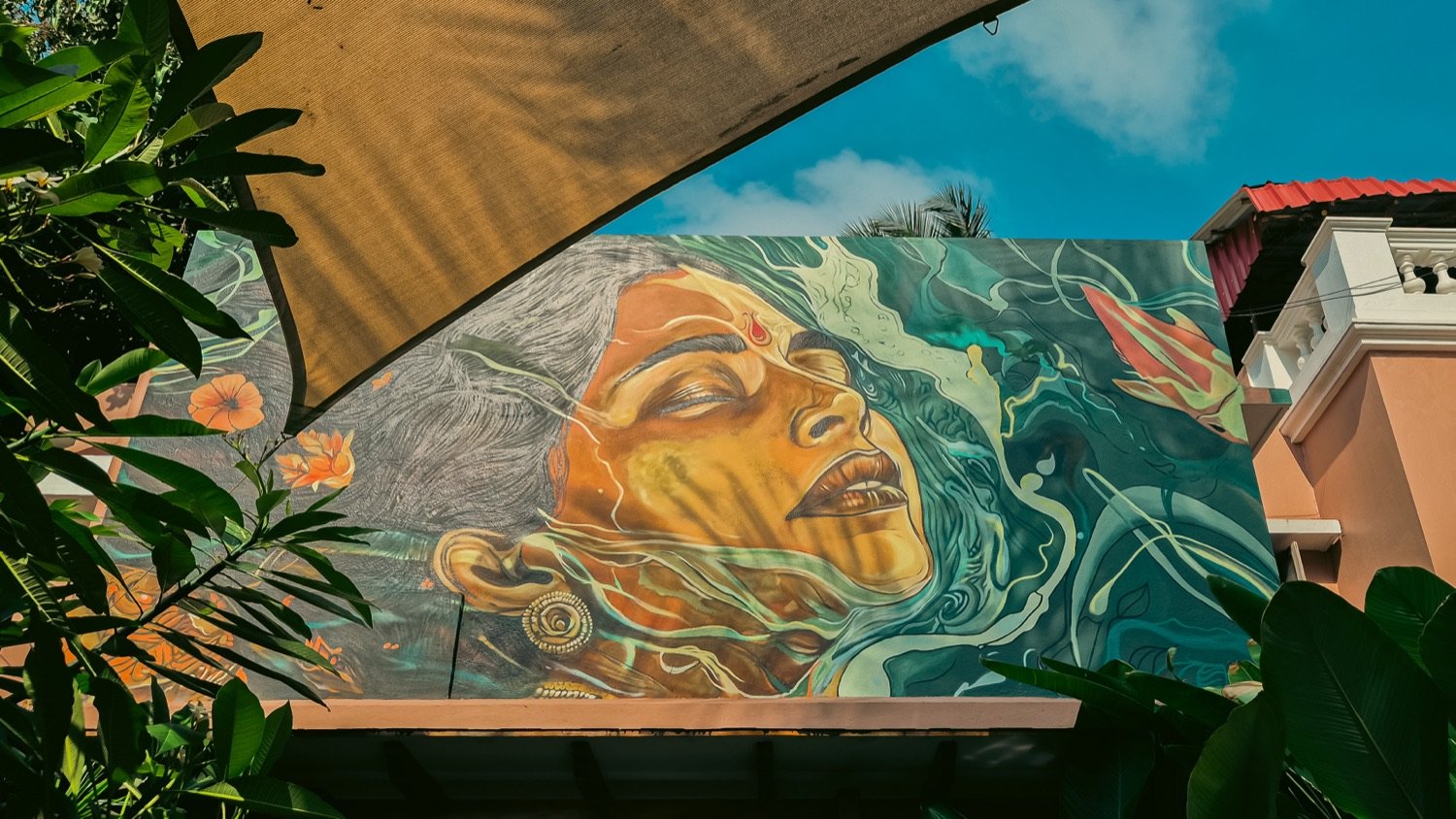Hand-painted mural of a face flowing into water