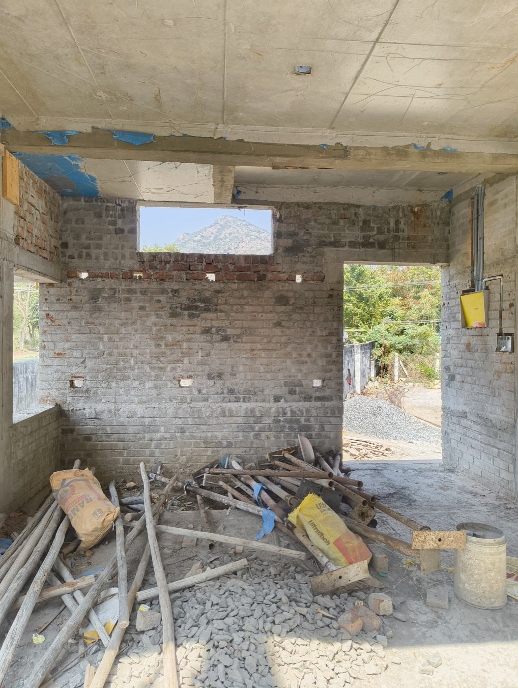 Site view of the unfinished house with brickwork and timber props